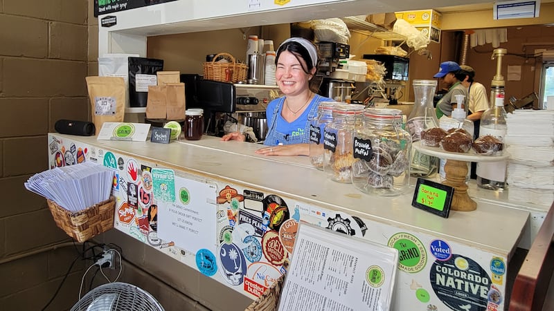 Kristin Sedlak, owner of The Grind smiles at camera.