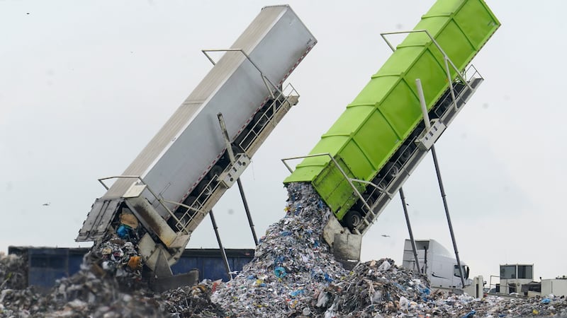 FILE - Garbage is unloaded into the Pine Tree Acres Landfill in Lenox Township, Mich., July...