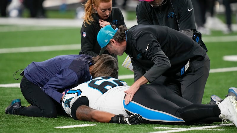 Carolina Panthers guard Chandler Zavala (62) is tended to after being injured in the first...