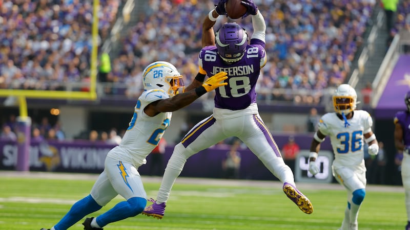 Minnesota Vikings wide receiver Justin Jefferson (18) catches a pass over Los Angeles Chargers...