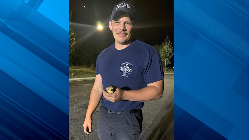 Firefighter/EMT Stowers with one of the rescued ducklings.