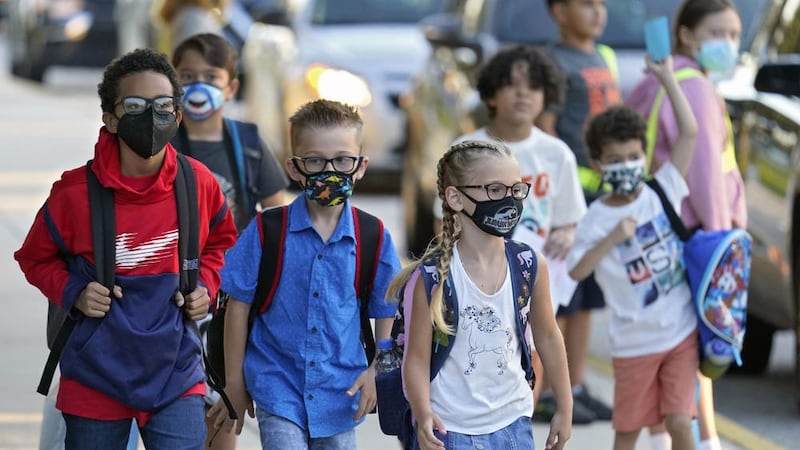 FILE - In this Tuesday, Aug. 10, 2021, file photo, students, some wearing protective masks,...