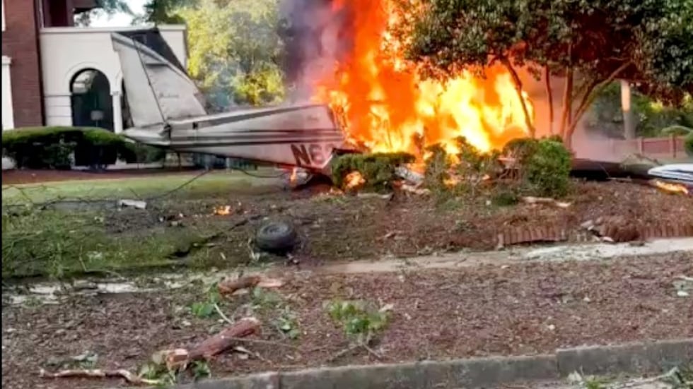 A single-engine plane burns after crashing Thursday in an Augusta neighborhood shortly after...