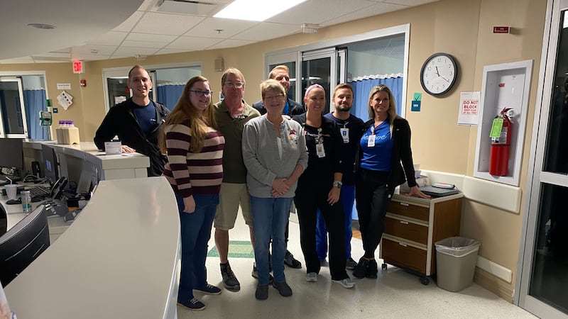 The Koberger family smiles with several members of the Grand Strand Medical Center team.