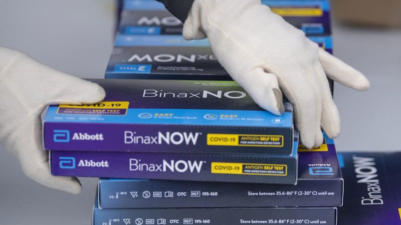 Youngstown City Health Department worker Faith Terreri grabs two at-home COVID-19 test kits to...